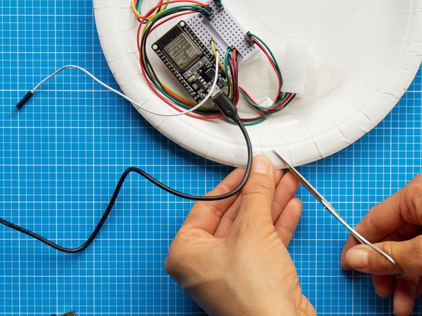 With a pencil, mark the outline of the USB lead where the cable touches the brim of the plate.