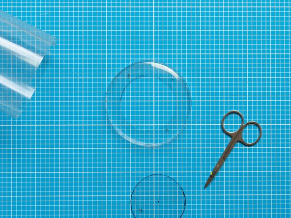 Using the same techniques as in the step above, perforate the opening for the fan and screws on this second lid.