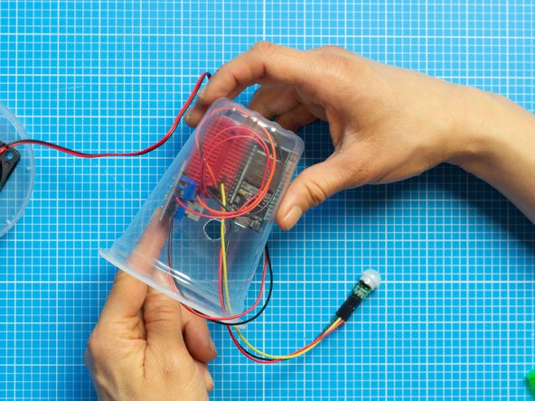 Place the breadboard assembly inside the top plastic tub.