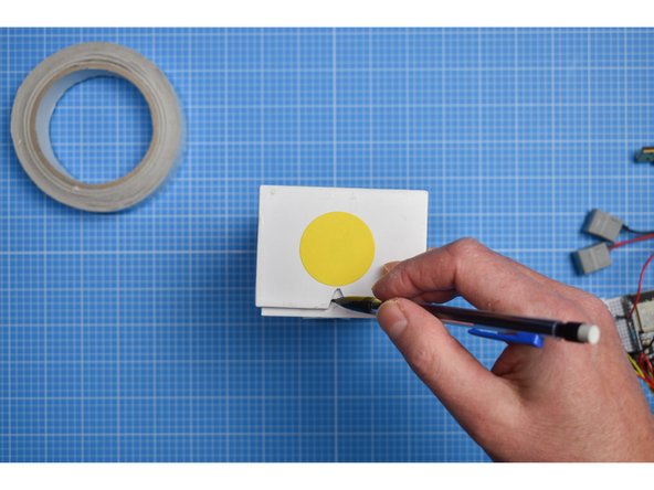 Close the box and make a small mark on the inner sleeve that traces the triangle you have just cut.