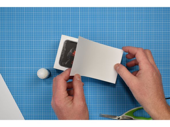 Lightly trace around the lid of the box onto the white card. Cut out and stick to the box using a glue stick.