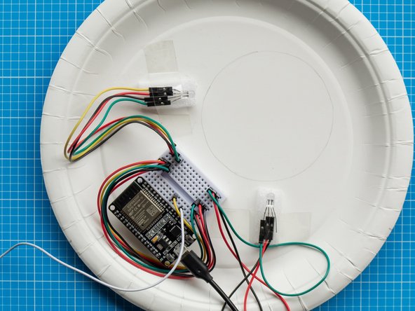 Once you have decided the right position of both lights, secure the LEDS to the plate with sellotape. Use two foam strips (from ESP32S board packaging) as spacers to elevate the LEDS from the plate.
