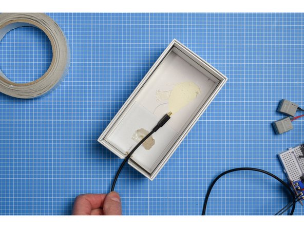 Using the mark you made in the previous step, mark and cut a slot in the inner sleeve large enough for the USB lead to pass through.