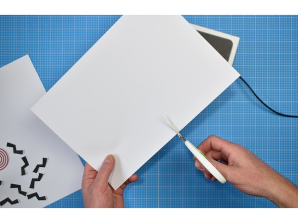 Lightly trace around the lid of the box onto the white card. Cut out and stick to the box using a glue stick.