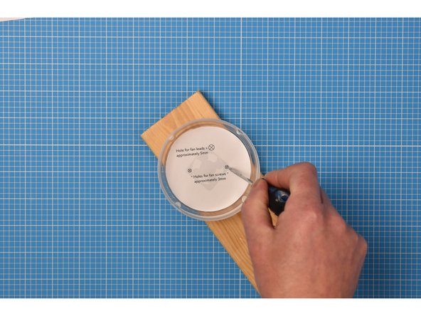 This step is about creating holes for the fan's leads and two mounting screws.