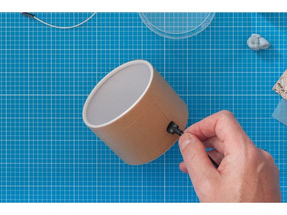 Create two small holes with your pointy tool.