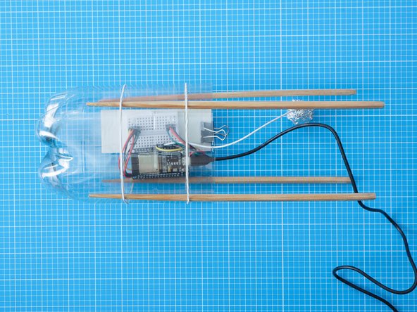 Make sure the chopsticks legs are all the same length from the ground . You can do this by marking the chopsticks with a pen, or aligning them to the horizontal marks on the bottle.