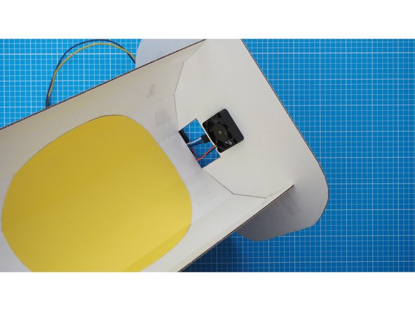 Feed the cable in from the back guiding it in underneath the flap.