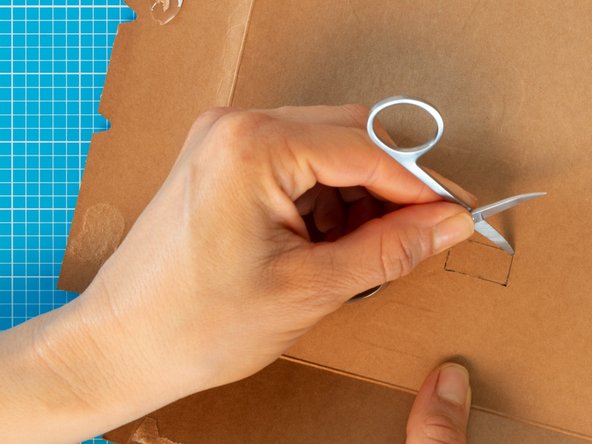 Starting from the hole in the centre, cut  out the rectangular shape with the nail scissors.