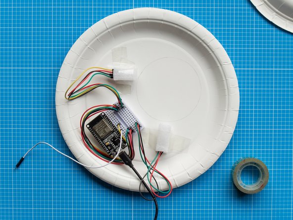 Place the two remainer foam strips on top of each LED and secure them with tape. These will act as a diffuser to the lights.