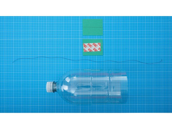 Cut and align the thread along the line, then use double-sided tape (or a glue stick) to bond the paper and thread together.