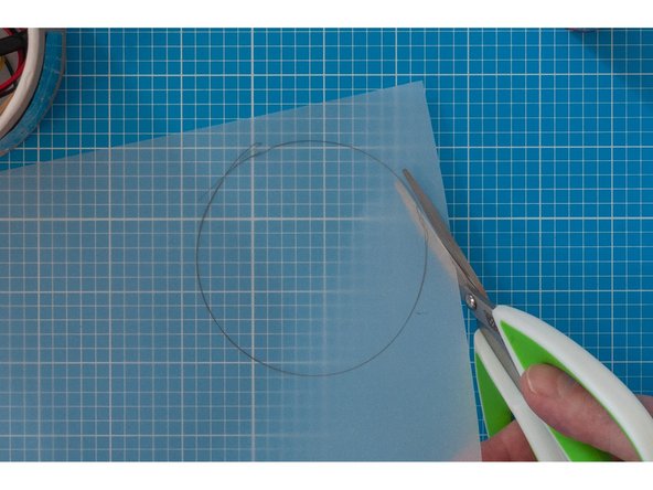 Trace a circle on the tracing paper around the top of the lid and cut out using scissors.