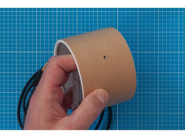 Try to arrange the lead so that the pointy connector is resting against the outside of the container -  in the next step we are going to place aluminium foil over the lead and it will puncture the foil if it is sticking out.