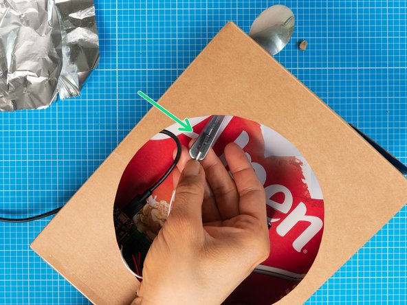 The capacitive touch button is how you operate the Speed Dial device. In this example, we will make the button out of a spoon and aluminium foil, but other metallic elements (e.g washers, coins) also work.