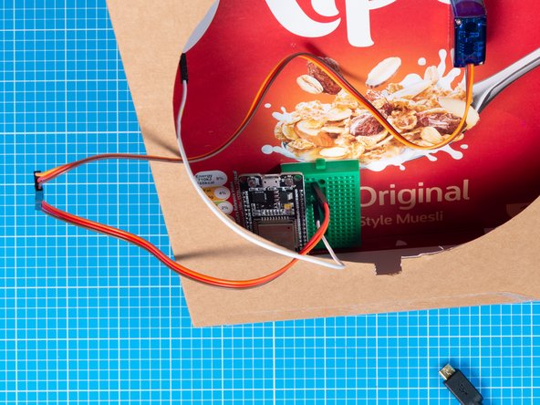 Position and fix the breadboard assembly inside the box. Align it to the bottom so that it can be supported by the base of the box.