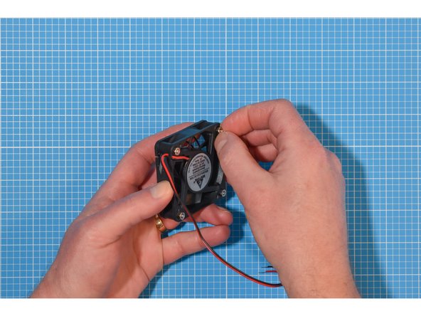 Insert the bolts through the grill and fan.