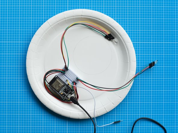 Fix the  breadboard assembly around the lighting area as shown in the picture. The breadboard has a double sided tape backing which can be used to attach it to the plate.