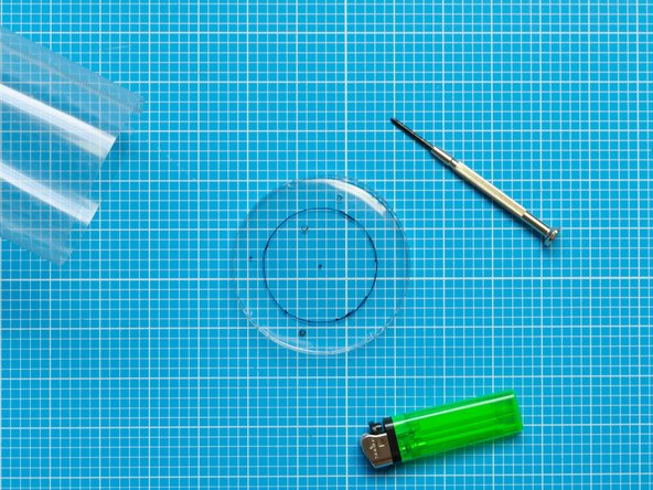 Using the same techniques as in the step above, perforate the opening for the fan and screws on this second lid.