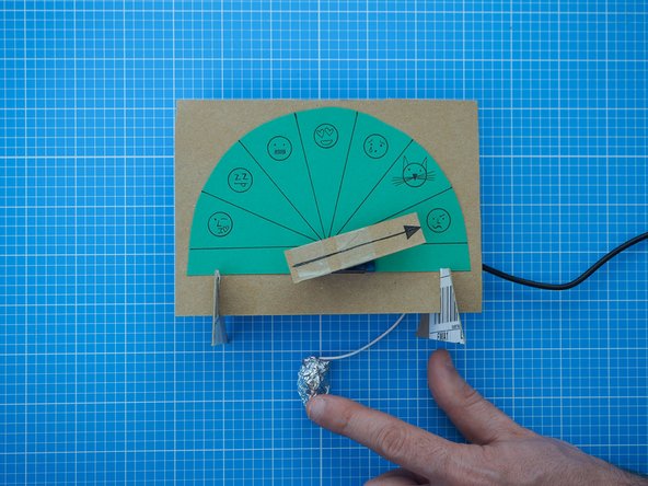 Tap the aluminium foil ball to move the pointer one notch. Your partner's pointer will move to the same position.