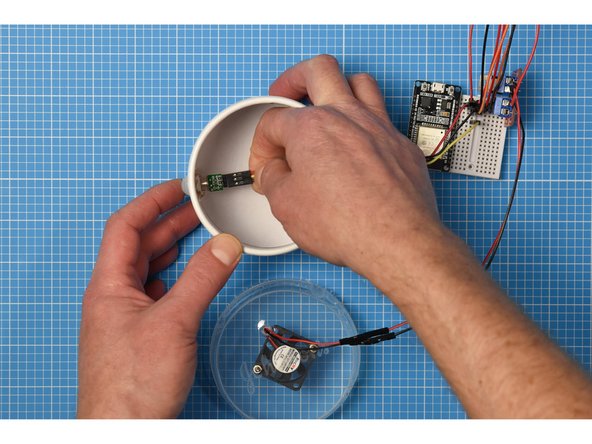 From inside the container, fit the PIR sensor back into the plastic cap to hold the PIR in place on the enclosure.