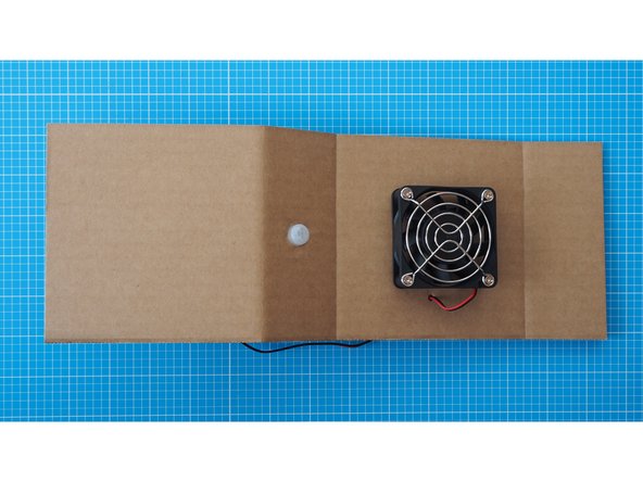 Fit the cap through the large hole you made in the second section earlier, from the front.