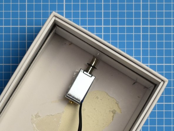 The striker end of the solenoid should be mounted a few millimeters from the side of the box.