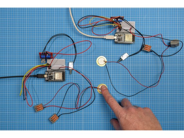 Tap on the first device's piezo sensor to make a unique knock sequence. You should be able to see your secret knock played back on the second device's solenoid.