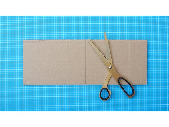 Cut a 12cm x 34cm rectangle of cardboard with a pair of scissors.