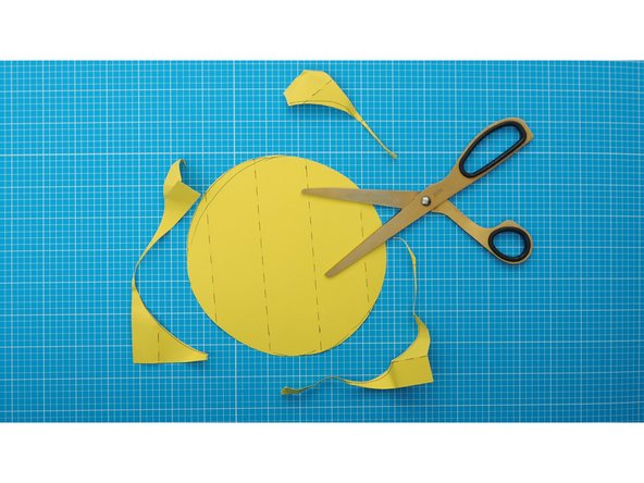 Fold the paper along the fold lines to create a 5 surfaced square by lightly scoring the edges with scissors and ruler.