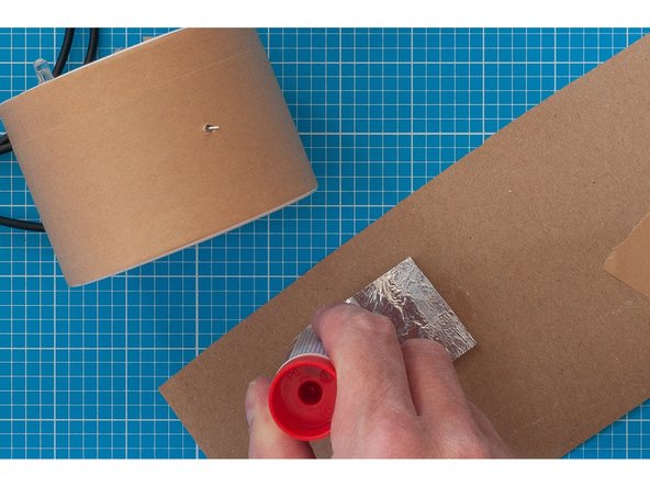 Use the glue stick around the outside of your shape, but not over the area that is going to touch the capacitive touch lead.