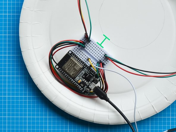 Position the breadboard at least 1 cm away from the marked area so that it remains hidden once you close the device.