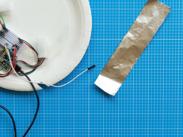 Cut a 4 x 18 cms  strip of aluminium foil and fold it in half in both directions until it is about 2 x 9 cms.