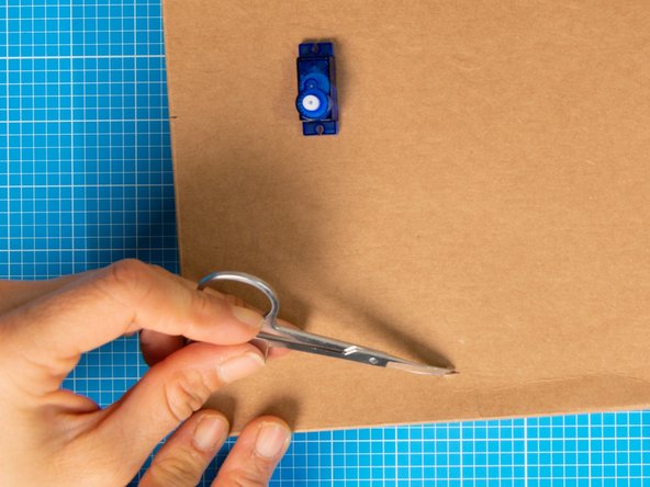 Position the dial in place and mark two slits where the clips will be inserted, on on top and a second on the bottom.