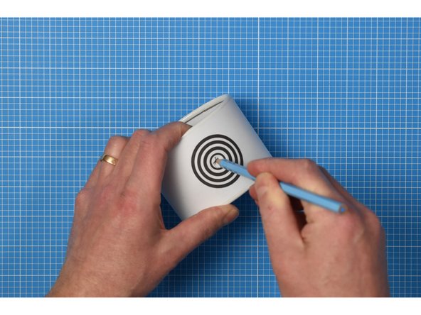 Gently enlarge the hole using a pencil.