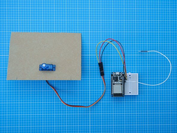 Insert the servo motor through the front of the card mount making sure the servo motor axis is centrally aligned to the mount as shown.