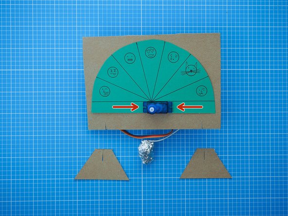 Add the dial to the front of the cardboard mount, clamping it between the servo motor brackets and the mount.
