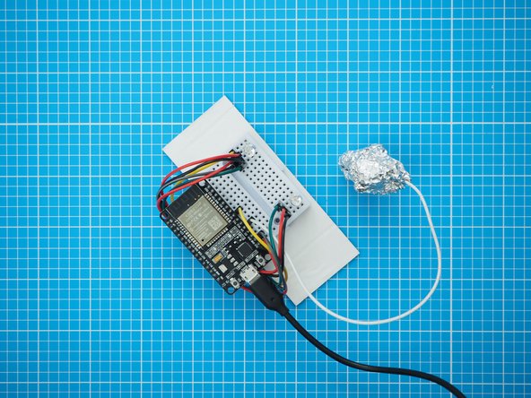 Mount the breadboard assembly on a small piece of cardboard that will fit inside the plastic bottle. The breadboard has a double sided tape backing which can be used to attach it.