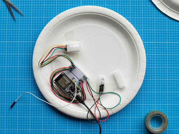 Place the two remainer foam strips on top of each LED and secure them with tape. These will act as a diffuser to the lights.