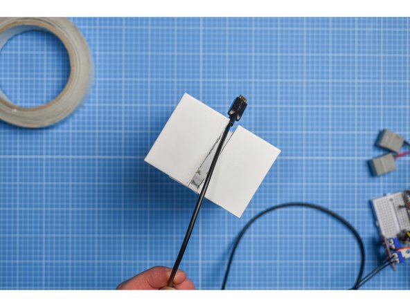 Using the mark you made in the previous step, mark and cut a slot in the inner sleeve large enough for the USB lead to pass through.