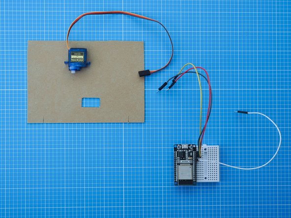 Separate the servo motor from the breadboard assembly by unplugging the cables.
