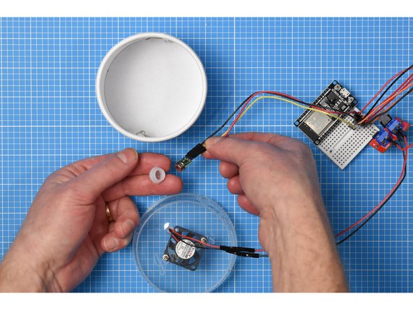 Remove the white plastic cap from the PIR sensor.