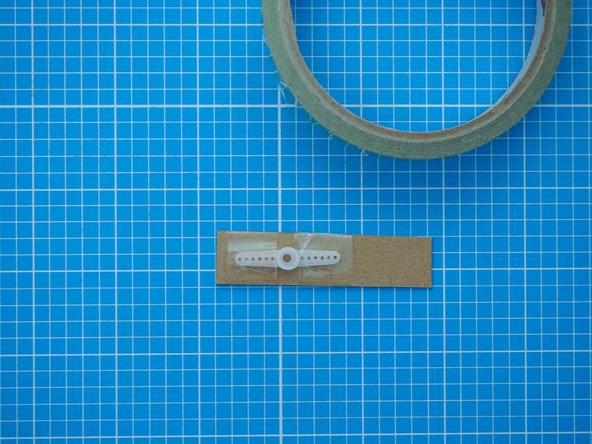Tape or glue it onto the servo motor arm.