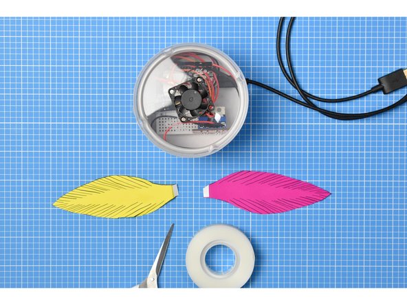 Place small pieces of double-sided tape on the tab of each feather.