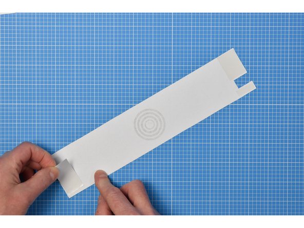 Add double-sided tape to each end of the wrapper.