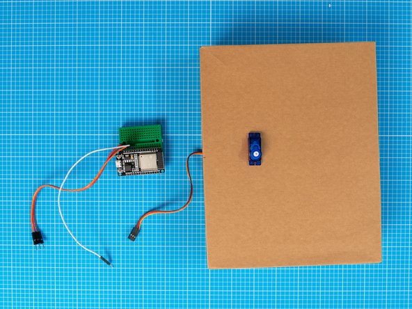 Separate the servo motor from the breadboard assembly by unplugging the cables.