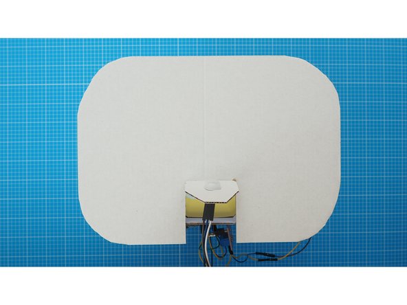 Fit the cap through the hole you made in the flap from the front.