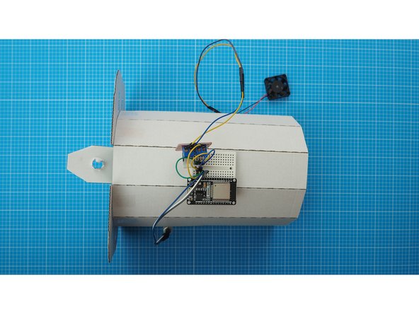 Mount the breadboard to the back of the faceted curve. The breadboard has a double sided tape backing which can be used to attach it.