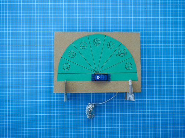 Add the two legs by sliding the grooves together. The tops of the legs should further secure the dial in the position.