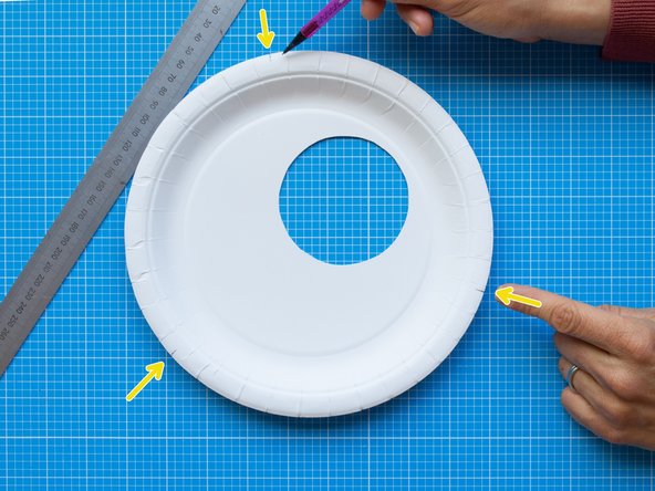 Mark three equidistant points along the edge of the plate. These points will be the guides for positioning the bulldog clips that will  hold together the lamp.