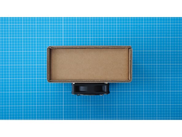 Fix the cardboard piece into the side of the enclosure. Use the side that is further from the MOSFET module and usb cable connector.